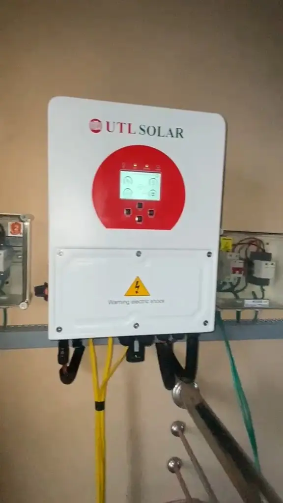 Solar inverter installed beside an electrical distribution box